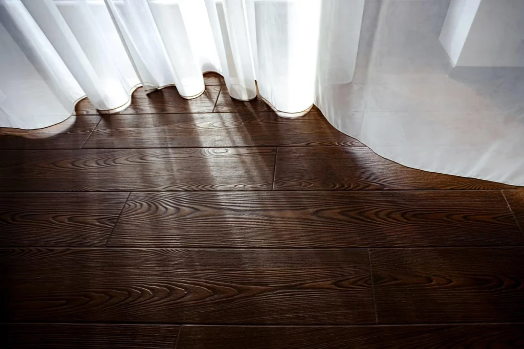 Comparison image of solid hardwood and engineered wood flooring materials