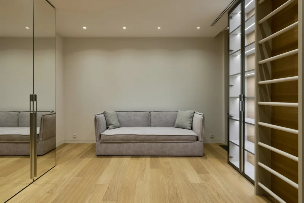 Solid wood plank beside engineered wood plank with visible layered core