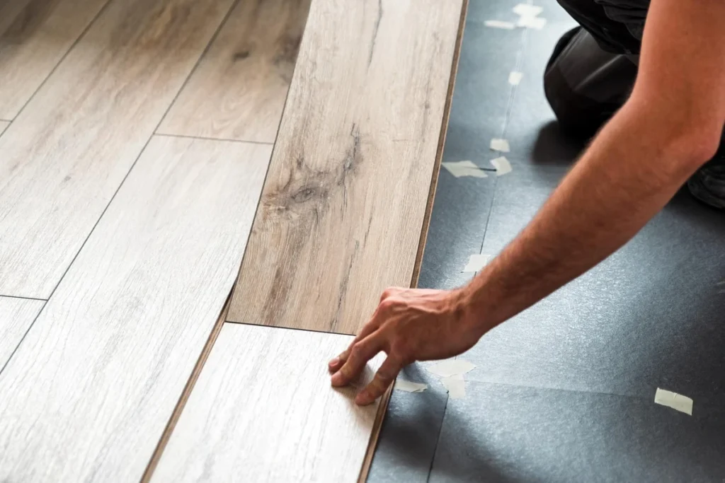 Laminate flooring layers showing wear layer, design layer, HDF core and backing