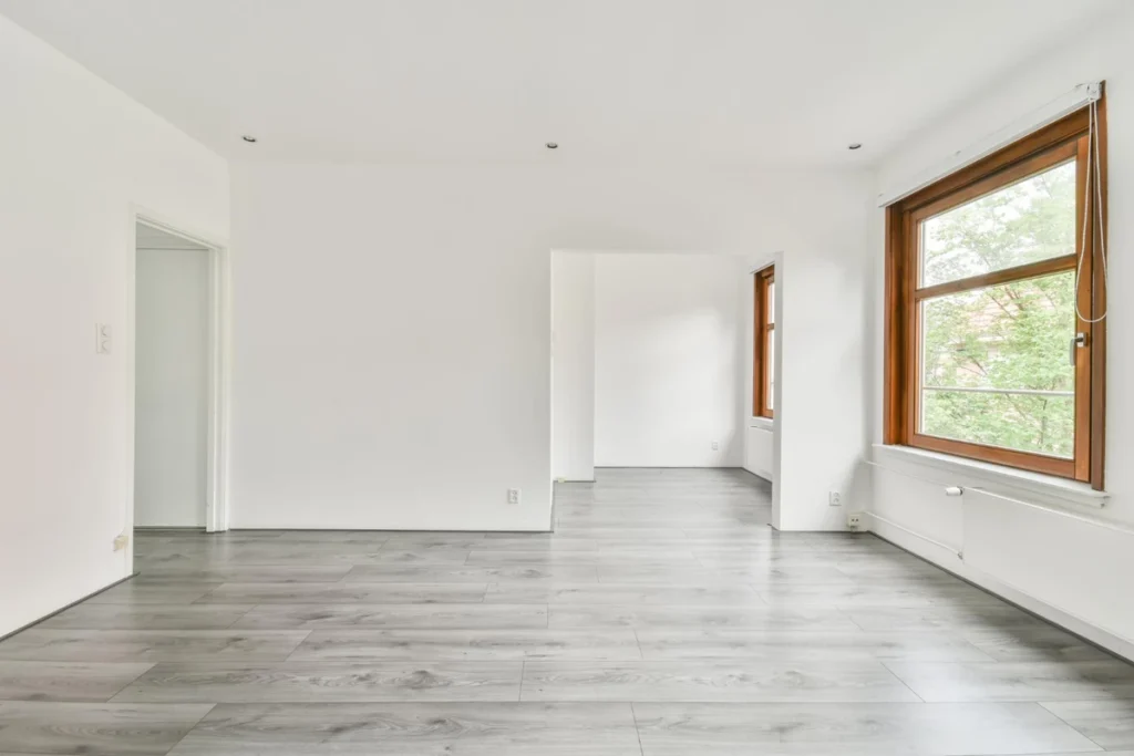 Bedroom interior with warm laminate wood flooring