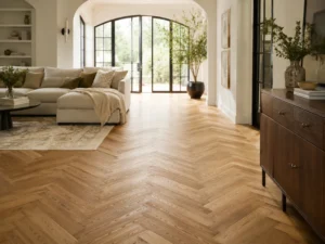 Natural oak herringbone flooring in a bright, elegant living room