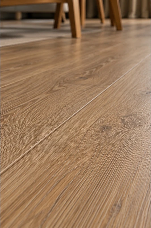 Warm oak micro-bevel flooring featuring subtle grooves between laminate planks and a natural wood grain texture
